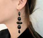 5 link black enamel oval and circles earring on gold wire on model