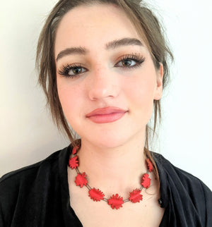 
                
                    Load image into Gallery viewer, abstract red shapes necklace on model in black shirt
                
            