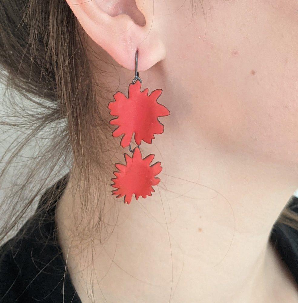 red double abstract flower earring on model