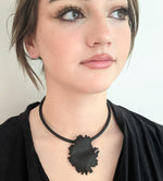 Black peony silhouette necklace on model