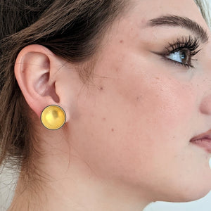 
                
                    Load image into Gallery viewer, gold enameled bowl earrings on model
                
            