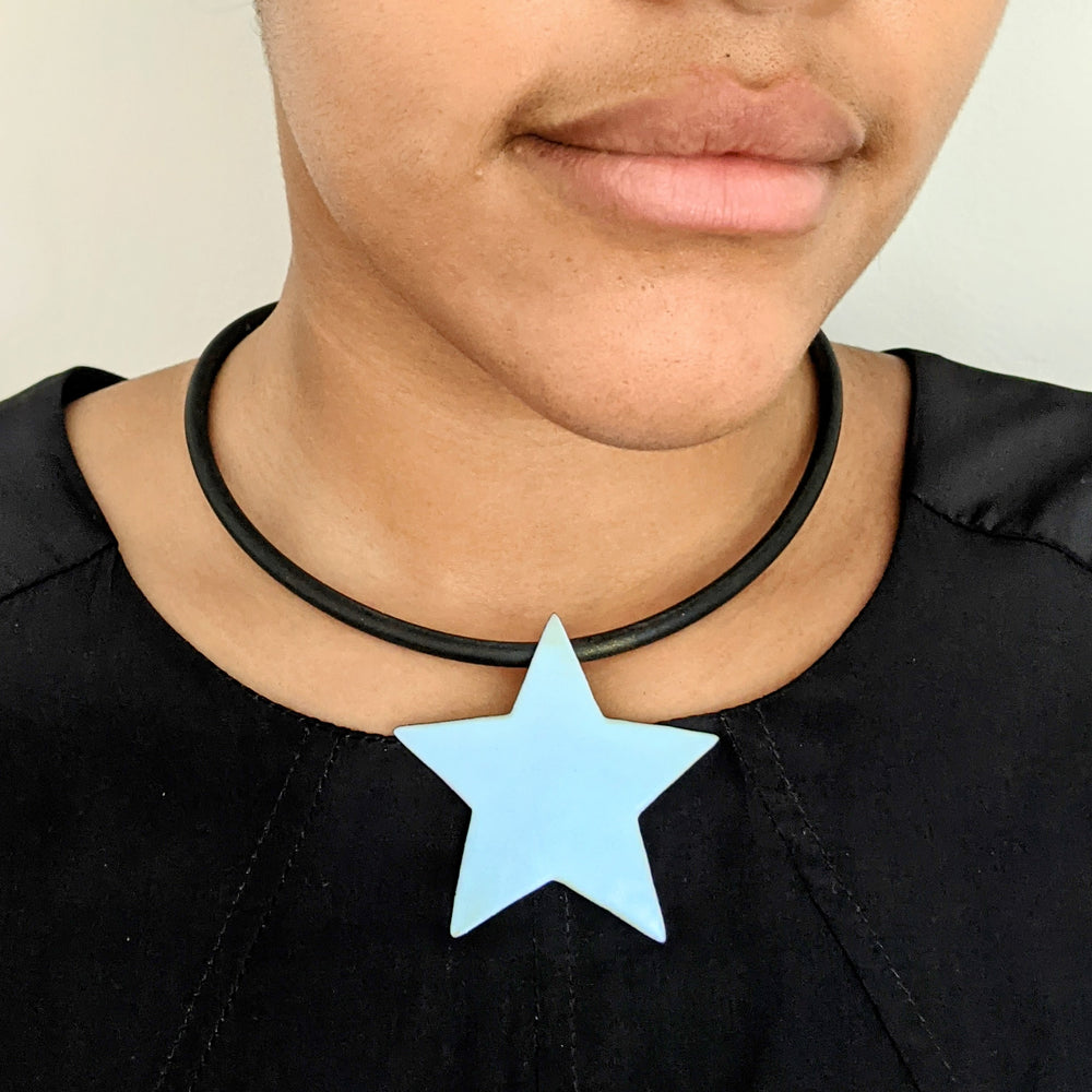 
                
                    Load image into Gallery viewer, pastel blue star necklace on model
                
            